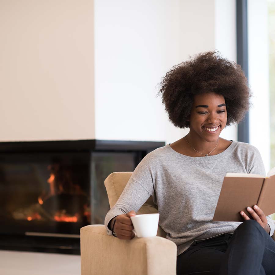 woman in front of propane fireplace in Hartford, CT