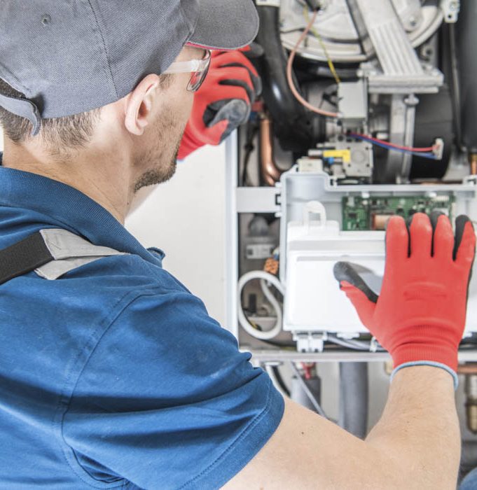 Wyman Energy technician installing a furnace.